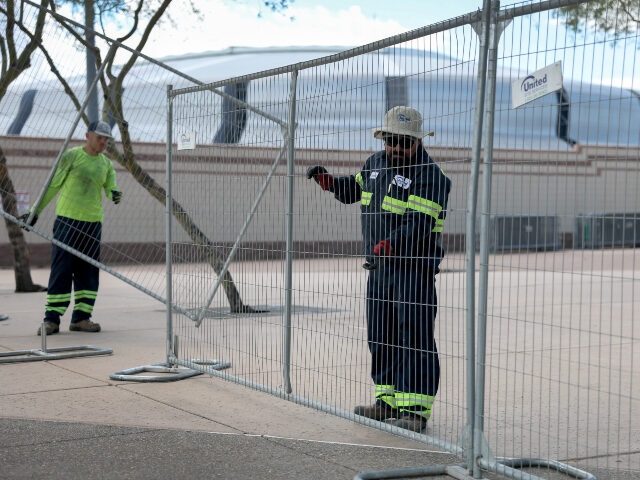 Workers prepare State Farm Stadium for Charlie Kirk's Memorial Workers install security fencing near the State Farm Stadium, home of the Arizona Cardinal