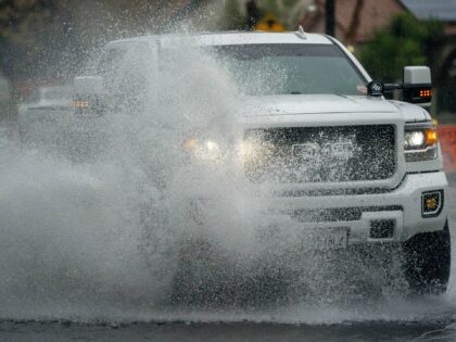 A truck drives through floodwaters in Rialto, California, US, on Tuesday, Feb. 6, 2024. Th