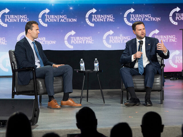 Turning Point executive director Charlie Kirk (L) moderates a conversation with US Senator