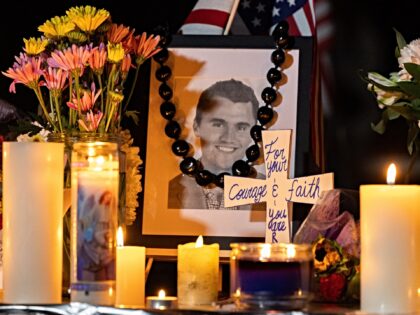 Candles and flowers are seen near a portrait of right-wing activist Charlie Kirk at a make