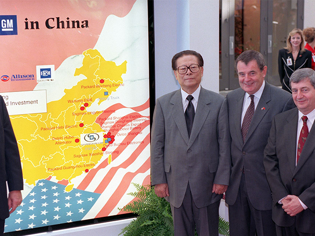 Chinese President Jiang Zemin (left) poses in front of a map showing General Motors’ pre