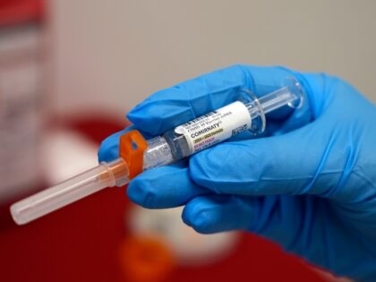 FILE - A pharmacist holds a COVID-19 vaccine at a pharmacy in New York, on Sept. 24, 2024.