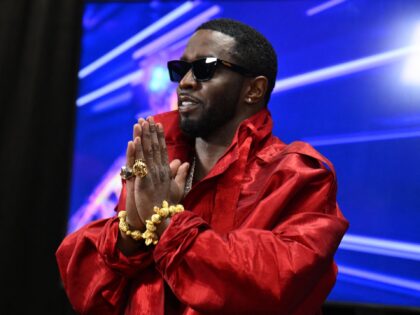 US producer-musician Sean "Diddy" Combs gestures in the press room during the MTV Video Mu