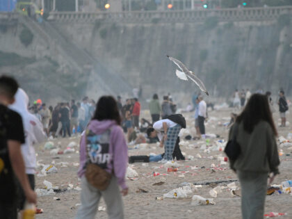 A CORUÑA, GALICIA, SPAIN - JUNE 23: Several people on the Orzan beach around debris after