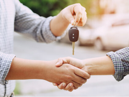 Businessman exchange handing over the car keys