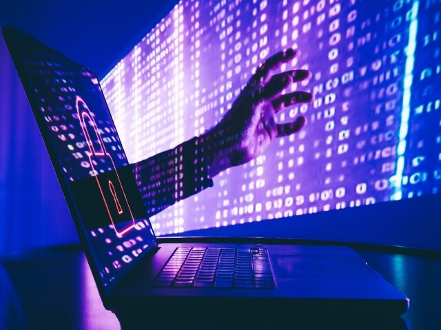 hacker reaching through laptop