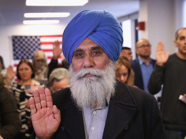 NEWARK, NJ - JANUARY 22: Indian immigrant Darshan Darshan, 64, takes the oath of allegianc
