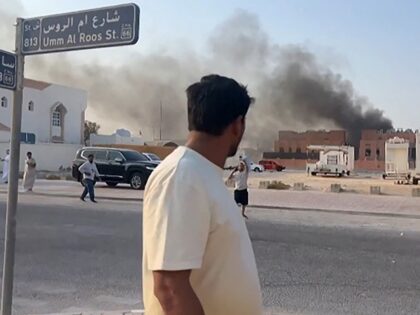 This frame grab taken from an AFPTV footage shows a man looking at smoke billowing after e