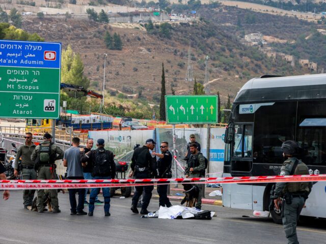 EDITORS NOTE: Graphic content / Israeli security forces gather by a body next to a bus at
