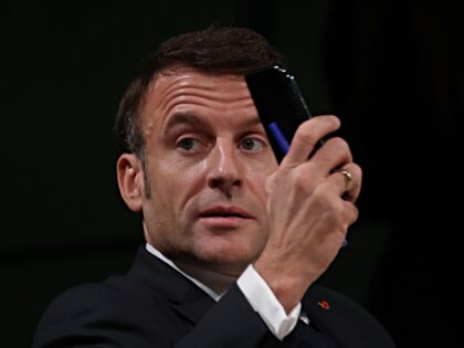 DUBAI, UNITED ARAB EMIRATES - DECEMBER 01: French President Emmanuel Macron holds up his s