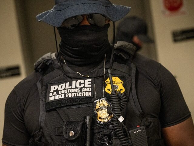 masked ICE agent