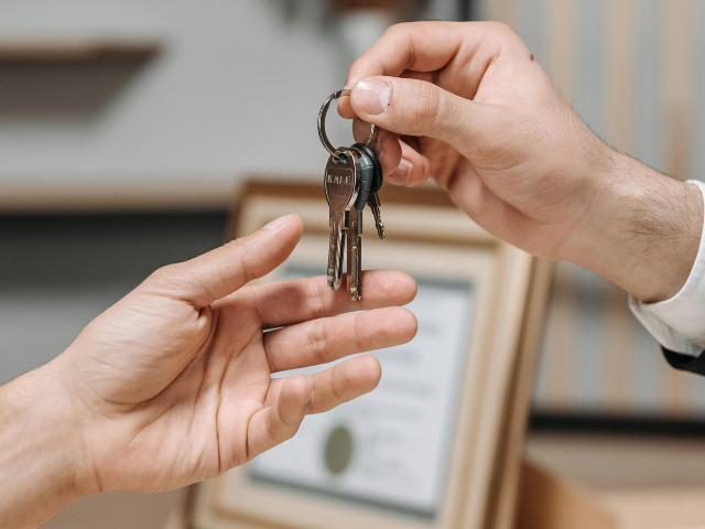A Person Handing the Keys