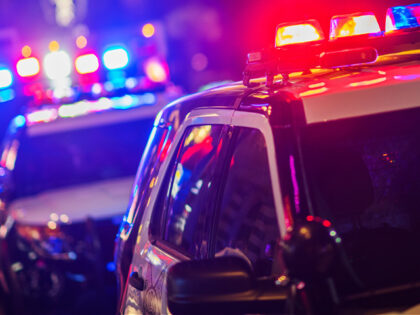 Night Time Police Violent Crime Intervention. Police Vehicles with Flashing Lights.