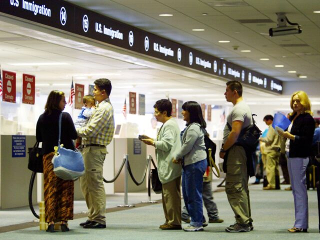 us border check Visa-Free MIAMI - JULY 2: People wait in line to have their passports checked by Immigration inspect