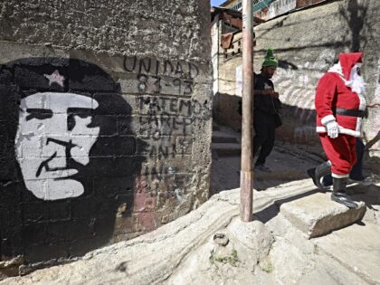 CARACAS, VENEZUELA - DECEMBER 21: A man dressed as Santa Claus arrives to hand toys to chi