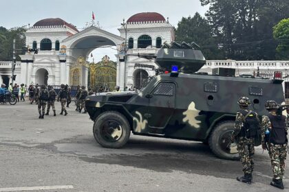 Army personnel patrol along a street outside the Singha Durbar, the main administrative bu