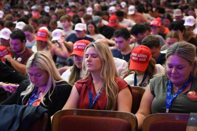 Attendees pray at a Turning Point USA event at Virgina Tech University