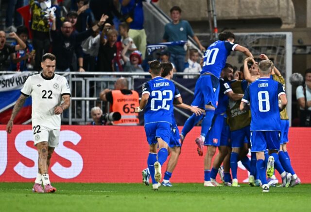 Germany's David Raum walks away as Slovakia players celebrate the second goal in thei