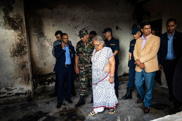 Nepal's interim leader Sushila Karki (C, inspecting a torched police station) vowed t