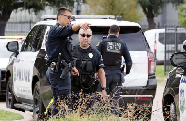 Police investigate the scene where a shooter opened fire on a US Immigration and Customs E