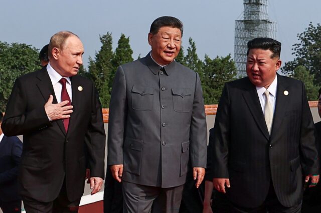 (L-R) Russia's President Vladimir Putin walks with China's President Xi Jinping