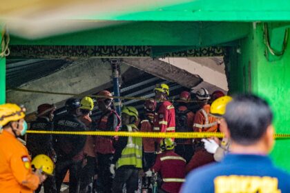 Searchers raced to rescue dozens of people still believed trapped a day after the collapse