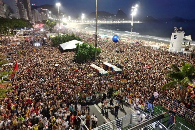 Tens of thousands sing along at a 'musical protest' on Copacabana Beach against