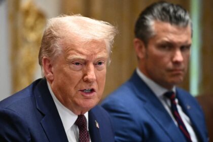 US President Donald Trump sits alongside Secretary of Defense Pete Hegseth at an August, 2