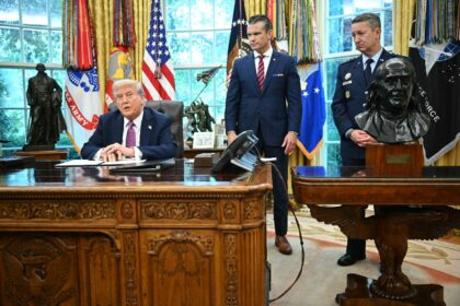 US President Donald Trump (L) speaks to reporters as Secretary of Defense Pete Hegseth (C)