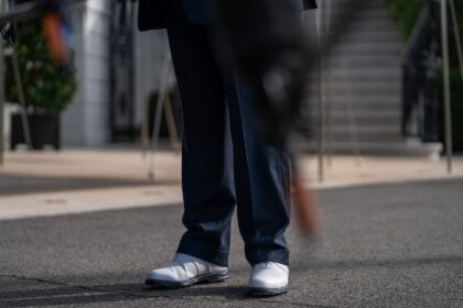 US President Donald Trump wears white golf shoes as he speaks to members of the press outs