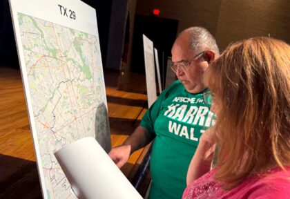 Voters look at a map to understand the new redistricting maps approved by Texas lawmakers