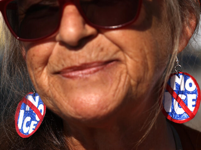 woman with No-ICE earrings Anit-ICE protester Mary Rose O'Leary wears the appropriate earrings while joining oth