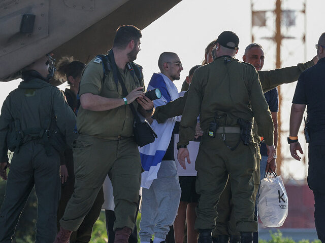 Israeli soldiers accompany Rom Braslavski, formerly held hostage in Gaza since October 202