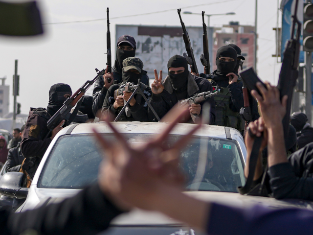 FILE - Members of the al-Qassam Brigades, the armed wing of Hamas, take part in a parade a