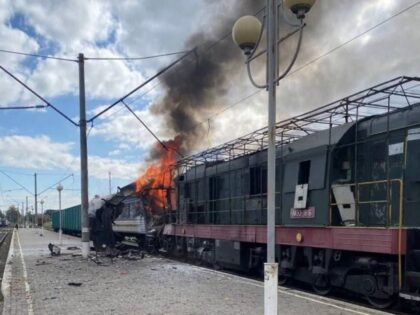 In this photo provided by the Ukrainian Railway press office, a passenger train is engulfe