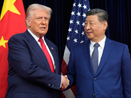 President Donald Trump, left, and Chinese President Xi Jinping shake hands before their me