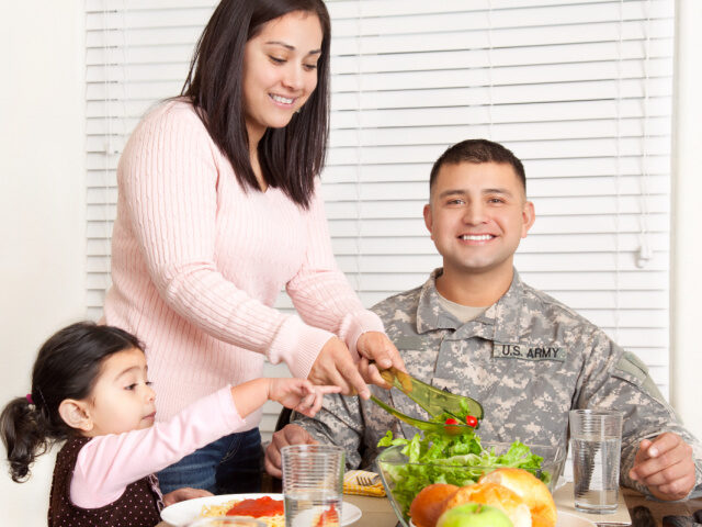 Real American army family having dinner. DanielBendji/Stock Photo/Getty Images