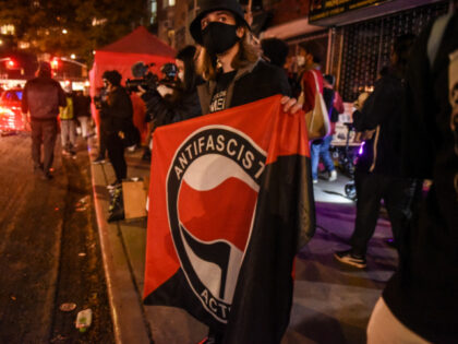 A demonstrator holds an Anti-fascist banner at a protest during the 2020 Presidential elec