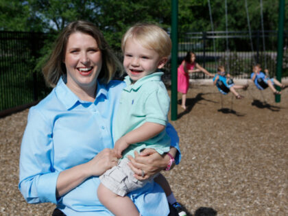 In this May 29, 2014 photo, Christy Wolford, a breast cancer survivor, holds her youngest