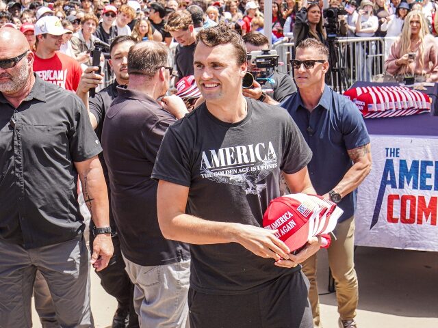 Charlie Kirk giving out hats at event