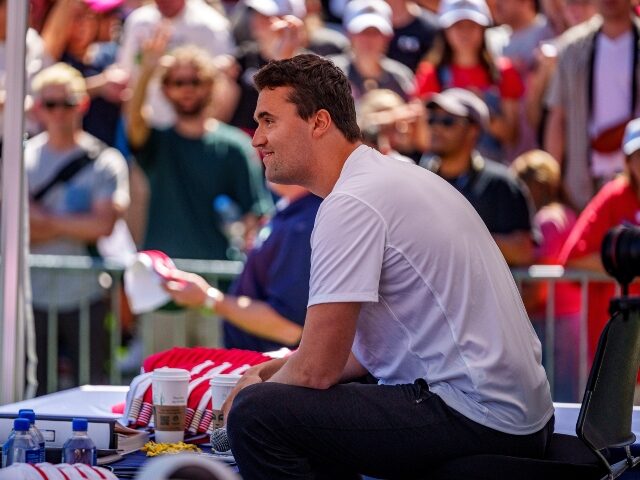 Charlie Kirk smiles at audience