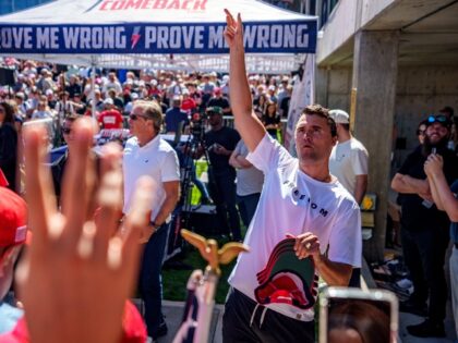 Charlie Kirk throwing hats at his final event
