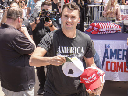 Charlie Kirk, founder of Turning Point USA, throws hats to the public. Turning Point USA f