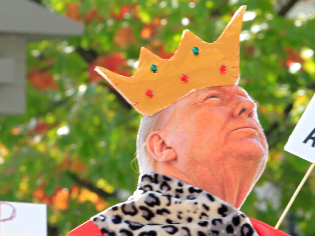 Cutout of Donald Trump Wearing Crown Participants hold signs during the No Tyrants Toronto mass protest event, in conjunction w