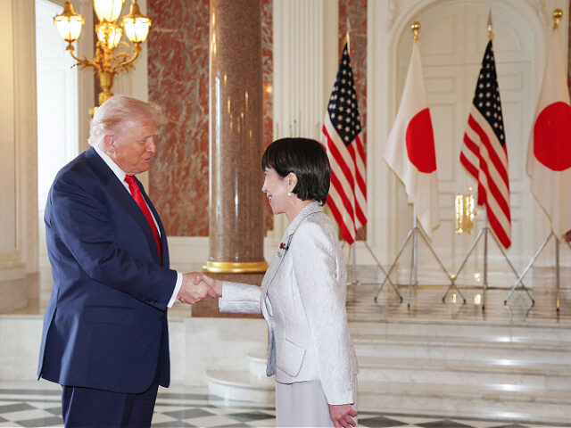 Japan's Prime Minister Sanae Takaichi (R) greets US President Donald Trump at the Akasaka