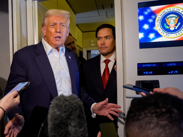 U.S. President Donald Trump, accompanied by U.S. Secretary of State Marco Rubio (R) and U.