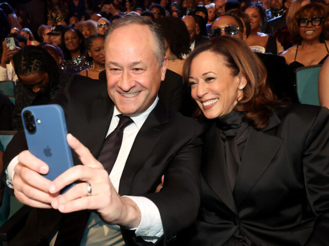 Doug Emhoff and Former Vice President Kamala Harris pose for a selfie photo during the 56t