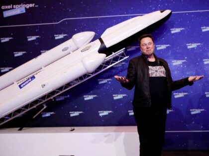 Elon musk poses with SpaceX ship