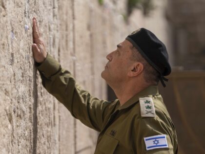 Israel's incoming military chief of staff, Lt. Gen. Eyal Zamir places notes in the We
