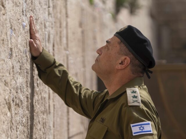 Israel's incoming military chief of staff, Lt. Gen. Eyal Zamir places notes in the We